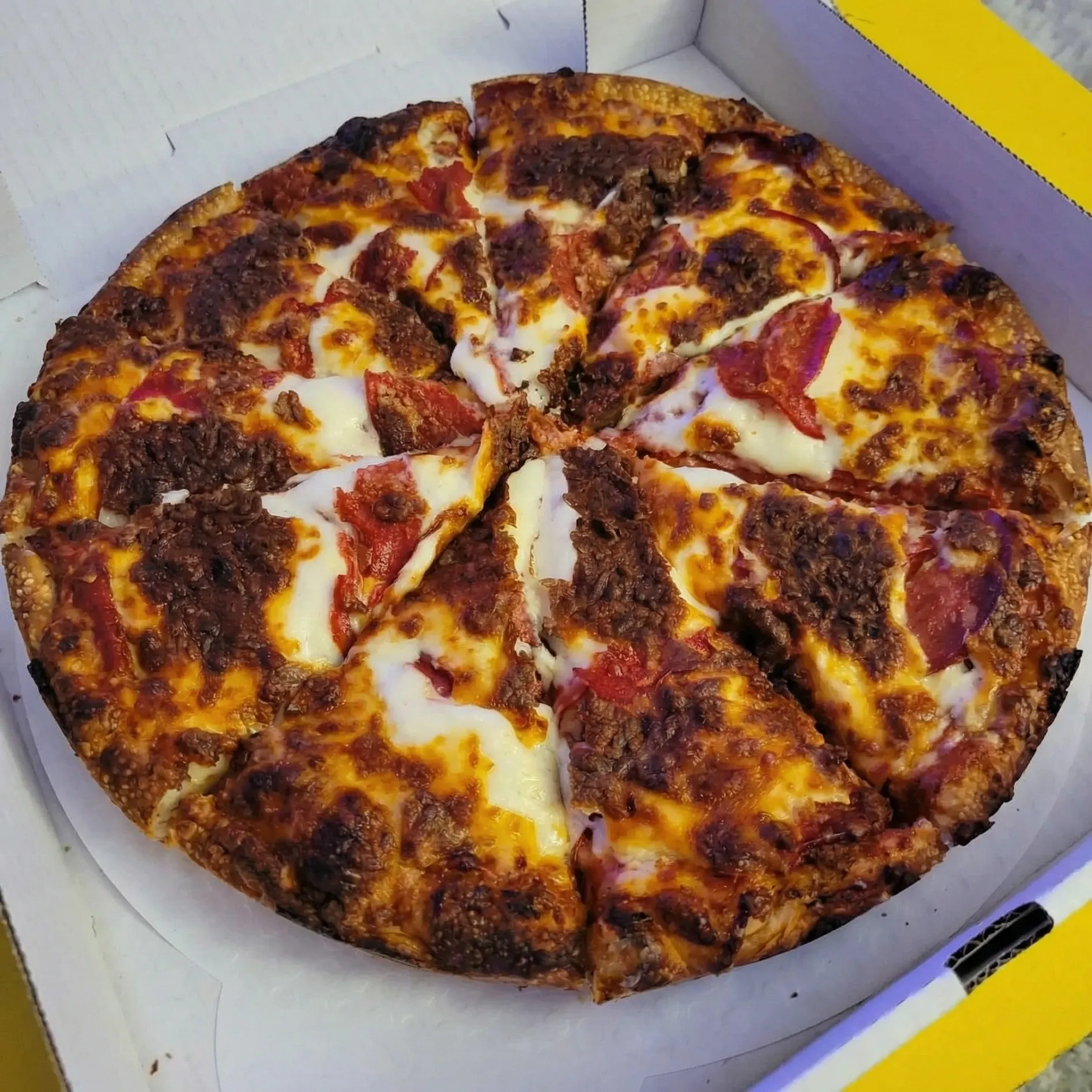 Pepperoni Pizza at Capital Pizza & Steak House Edmonton - deep-dish pizza with tangy house sauce and crisp-edged pepperoni